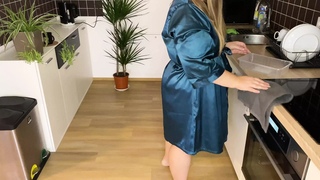 Sexy mother-in-law in a silk robe pees in the kitchen for her son-in-law