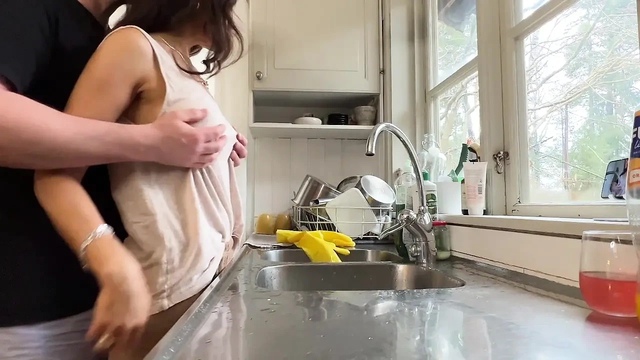 Horny wife gets fucked in the kitchen while doing the dishes